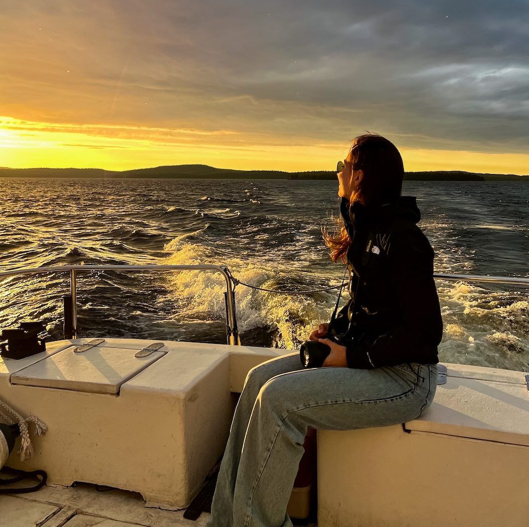 Midnight sun cruise. A person sitting on a boat enjoying the views over Lake Inari, Lapland Finland during the midnight summer in July. Photo by thenewjourney.nl