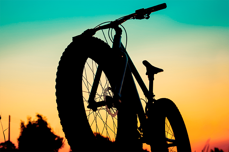 Shadow of a bicycle on sunset.