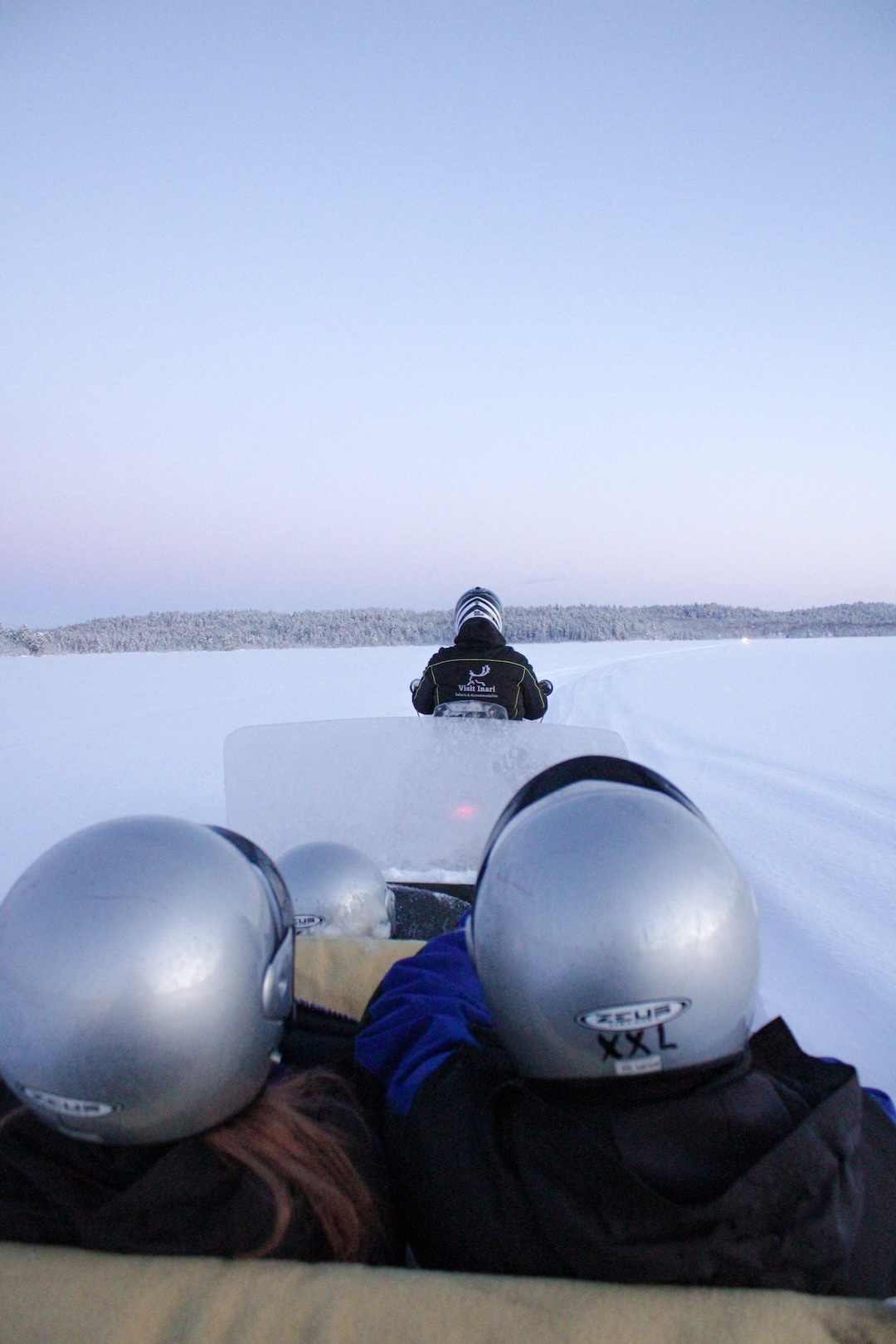 Snowmobile sleigh pulled on top of arctic lake in Inari Lapland Finland. Photo by Miika Leivo. 