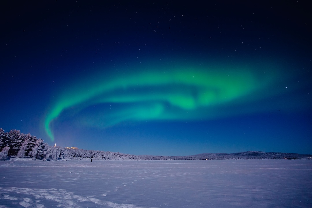 Green Northern Lights during winter over Lake Inari