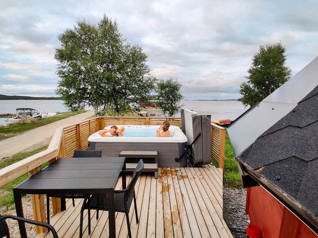 Ulkoporeallas terassilla järven ja metsän äärellä kesäisessä valossa.