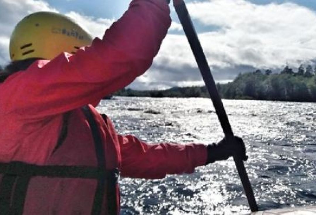 Rafter rowing on a river.