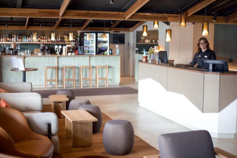 Hotel reception and lobby with modern wooden interior design.