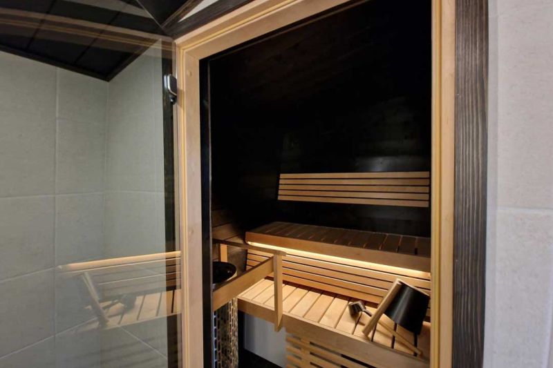 Sauna viewed fron the door, long sauna seatings and light coming from beneath.